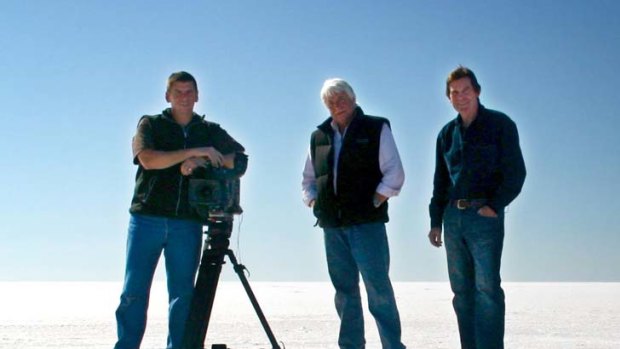 ABC cameraman John Bean, ABC helicopter pilot Gary Ticehurst, and ABC journalist Paul Lockyer stand on the salt pans at Lake Eyre in South Australia in June 2010.