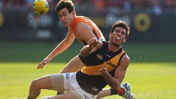 Here it comes: Richmond's Alex Rance gets the ball away before being tackled by Jeremy Cameron at Skoda Stadium on Sunday.