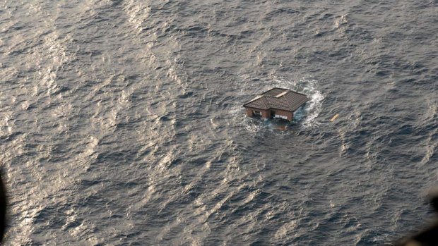 A Japanese home is seen adrift in the Pacific Ocean after the quake and tsunami struck.