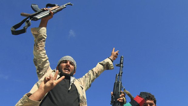 Anti-Gaddafi fighters celebrate the fall of Sirte.