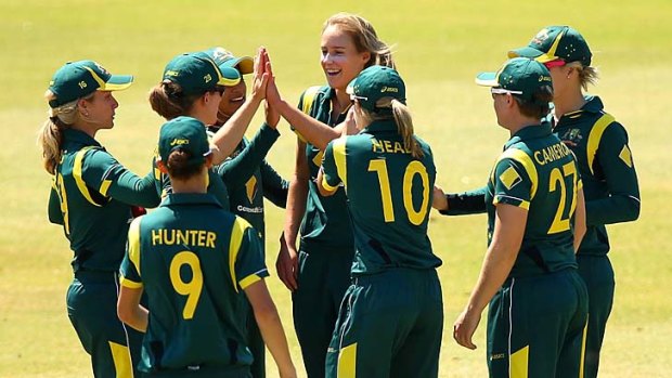 Ellyse Perry (centre) celebrates a wicket.