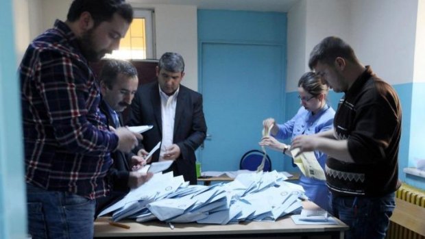 Electoral officers count votes at a polling station in Ankara.