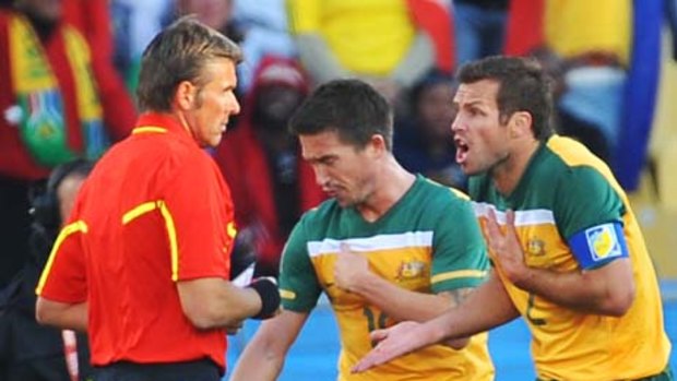 Australia's best player .... Lucas Neill, right, argues with the referee after Harry Kewell, background, was sent off.