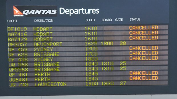Dim outlook ... the Qantas departure board at Melbourne airport.