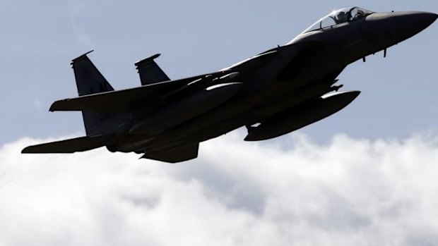 A US military jet flies over Vilnius during a Lithuanian-NATO air force exercise.