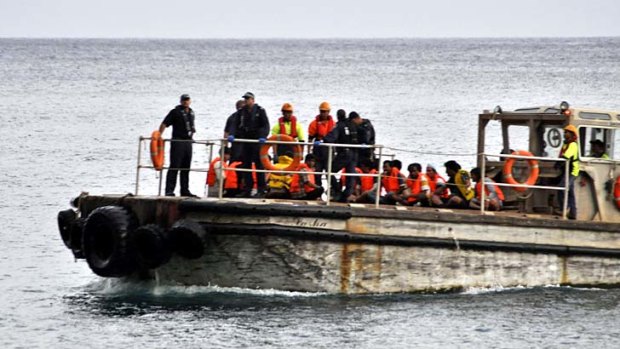 Tragedy &#8230; survivors are ferried to Christmas Island.