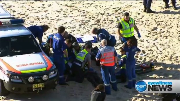 Rescue workers perform CPR on a surfer pulled from the water at Tamarama.