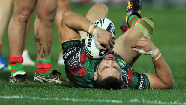 Greg Inglis lies on the ground after a hit that was judged high from Justin Horo.