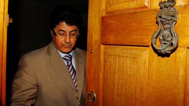 Libyan Ambassador to Australia Musbah Allafi shuts the door to the Embassy after being called into the Department of Foreign Affairs.
