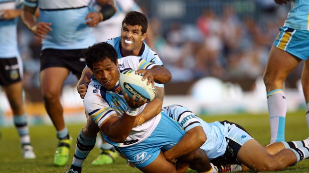 Saloon passage: Agnatius Paasi of the Titans scores in the tackle of Michael Ennis.