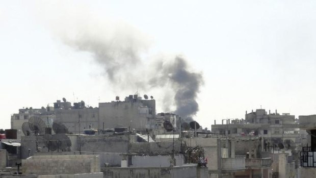 Smoke from shelling rises over the Khaldiyeh area in Homs city.