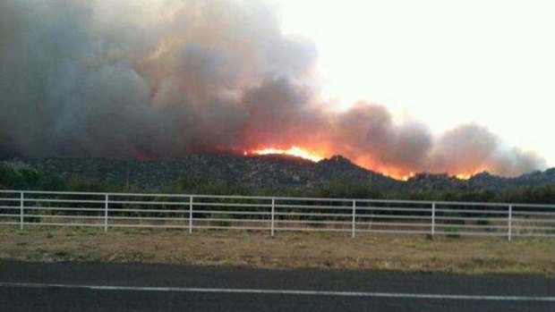 The Yarnell Hill fire is seen burning in this view from Highway I-17 near Yarnell, Arizona, in this handout photo taken June 29, 2013.