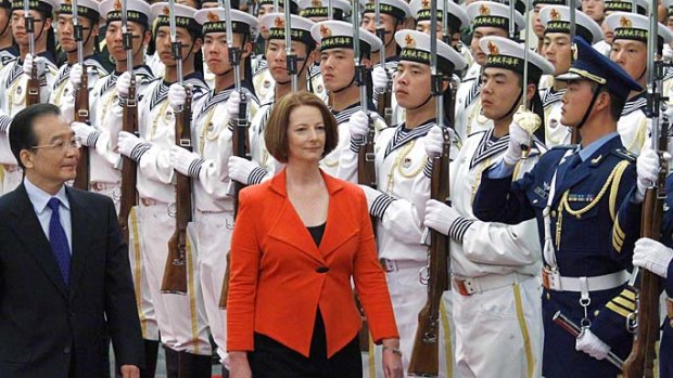 Chinese Premier Wen Jiabao and Prime Minister Julia Gillard inspect an honour guard during a welcoming ceremony in Beijing's Great Hall of the People yesterday. Ms Gillard is on a four-day trip to China.