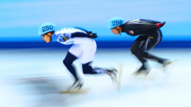 Streaks ahead: Russia's Victor Ahn and J.R. Celski of the United States compete in the Short Track Men's 5000m Relay.