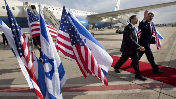"No illusions": US Secretary of State John Kerry walks alongside US ambassador to Israel Dan Shapiro as he arrives in Israel for a private meeting with Prime Minister Benjamin Netanyahu on Friday.