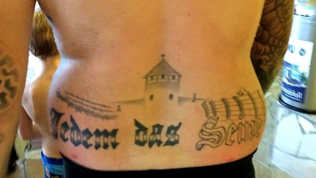 A member of Germany's extreme right-wing party shocks water park visitors with tasteless tattoo.