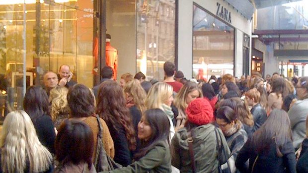 Shoppers queue to be among the first to part with their money at Zara's Bourke St store.