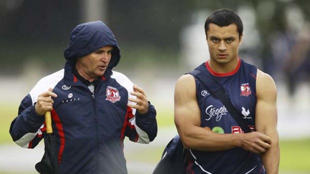 Lighter side ... Roosters coach Brian Smith shares a joke with his charges at training. He has had his critics over the years, not that he takes any notice of them.