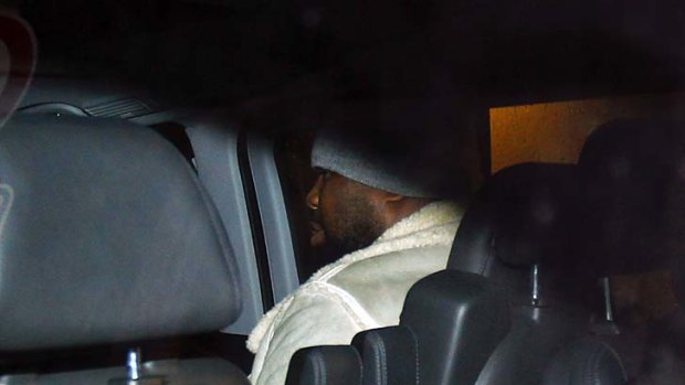 Going home ... Chisora, unseen, and his coach, pictured, leave Munich's main police station.