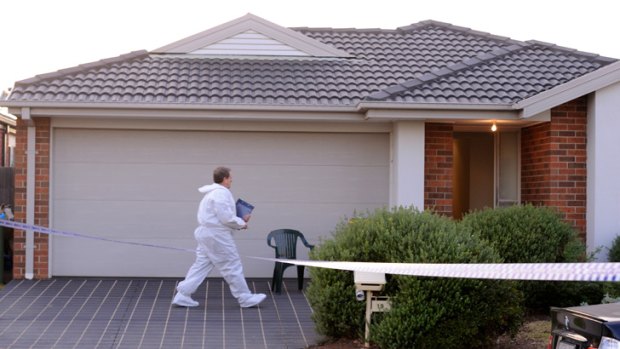 A forensic officer enters the house in Felicity Drive in Tarneit, where a man's body was found.