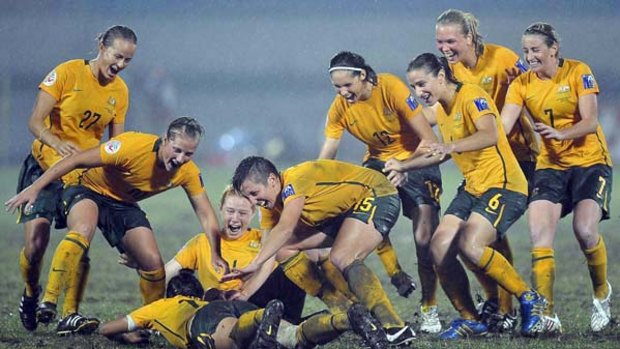 The Matildas celebrate after winning the Asian Cup in China.