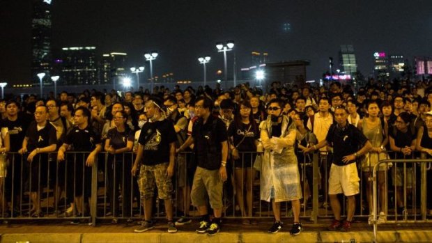 Protesters watch on from across the street at the entrance to the Chief Executive's Office in Hong Kong.