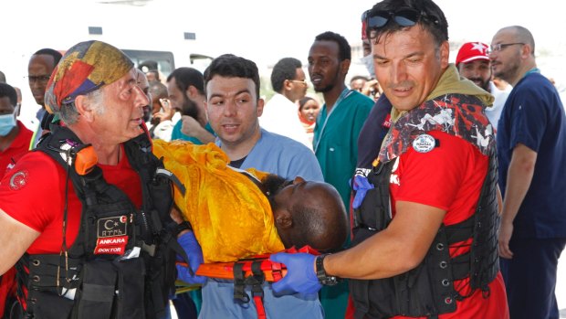 Turkish doctors transport a critically wounded man on stretcher into a waiting Turkish air ambulance.