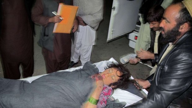A wounded Afghan girl is rushed to a hospital in Helmand province. 