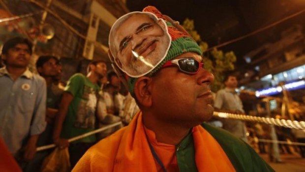 A supporter of India's main opposition Bharatiya Janata Party (BJP) wears headgear carrying a portrait of Hindu nationalist Narendra Modi, prime ministerial candidate for BJP during a public meeting in the old quarters of Delhi on Friday.