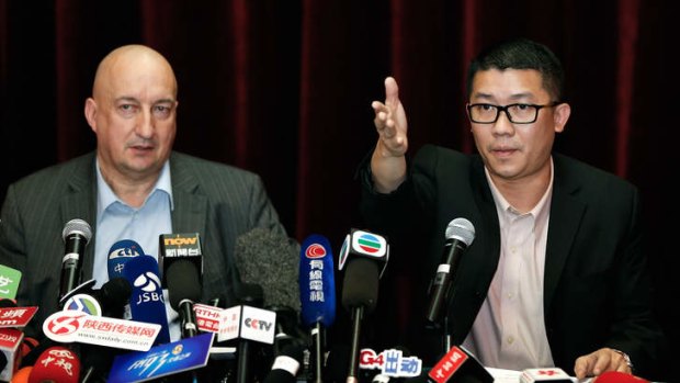 Damage control: Malaysia Airlines executives Hugh Dunleavy and Ignatius Ong address the media in Beijing.
