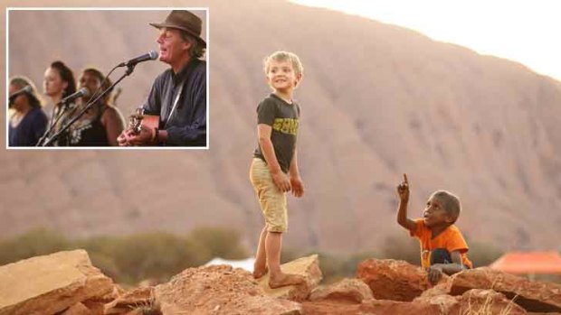 The community of Mutitjulu, at the base of Uluru, opens its gates as it celebrates the 30-year anniversary of Goanna’s Solid Rock, by Shane Howard (inset).