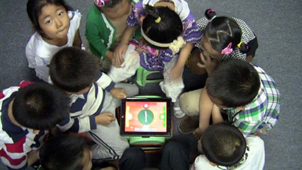 Kids in a classroom in Mongolia using INKids' Futaba Classroom Games app.