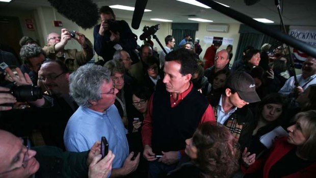 Rick Santorum talks to a voter in Brentwood, New Hampshire, his next campaign stop after his strong result in Iowa.