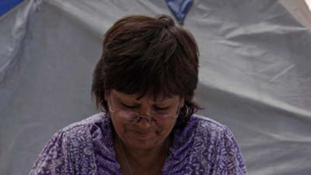 Griselda Godoy packs clothes to be sent to her son Carlos Barrios, who is trapped in the mine.