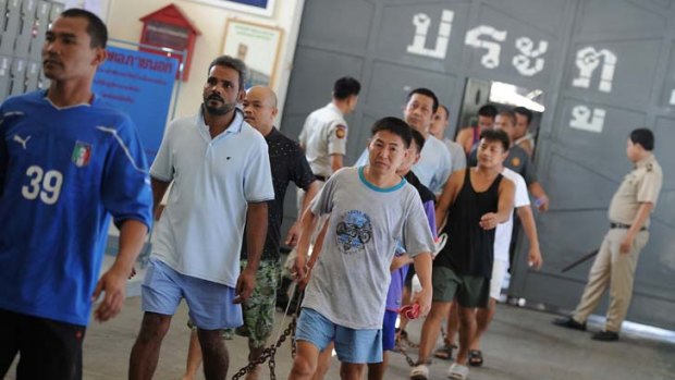Chain gang ... inmates leave Klong Prem Central Prison, one of several Bangkok prisons evacuated.
