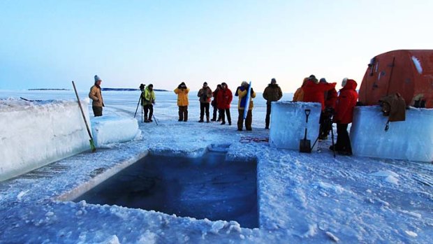 Expeditioners admire a hole they dug in readiness for their 2011 midwinter swim.