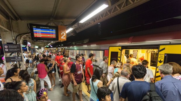 Large crowds are seen at South Bank Station on New Year's Eve as people catch trains to the celebrations.