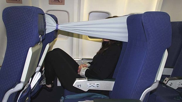 Strange flight accessories: New 'b-tourist' band provides seat privacy for  passengers