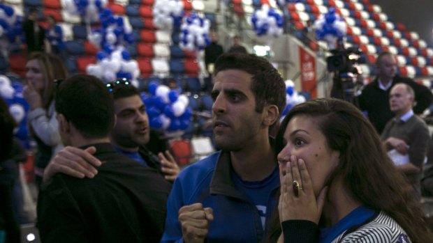 A Zionist Union party supporter reacts after hearing exit poll results in Tel Aviv on Tuesday.