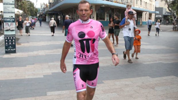 In the pink ... Tony Abbott helped promote The McGrath Foundation Ironman event, in Manly yesterday.