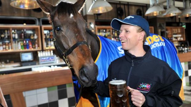 Jockey Kerrin McEvoy has a brew with Brew, the 2000 Cup winner.
