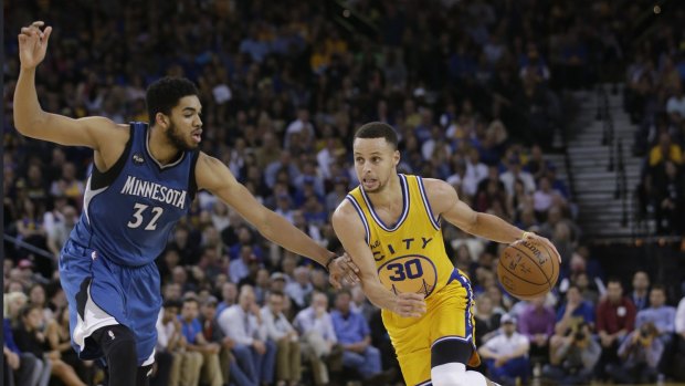 Last year's No.1 pick Karl Anthony Towns, left, up against Steph Curry. 