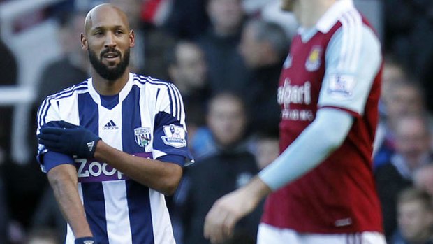 French striker Nicolas Anelka gestures as he celebrates scoring their second goal during the English Premier League match between West Ham United and West Bromwich Albion on December 28, 2013.