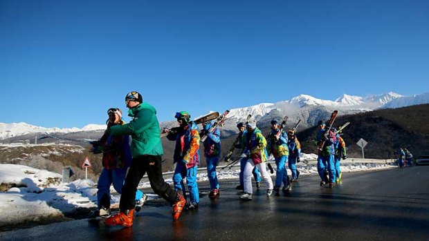 Course workers make their way to the finish area of the alpine skiing at the Rosa Khutor Alpine Centre in Sochi on Sunday.