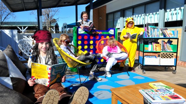 Reading in the new outdoor learning space at Bonython Primary school are, from left, Nek Stergiou,5 of Bonython, Nathanael Barons,10 of Isabella Plains, Ariadne Stergiou,11 of Bonython, Montana Gum,8 of Macarthur, and Cooper Gum,9 of Macarthur. 
