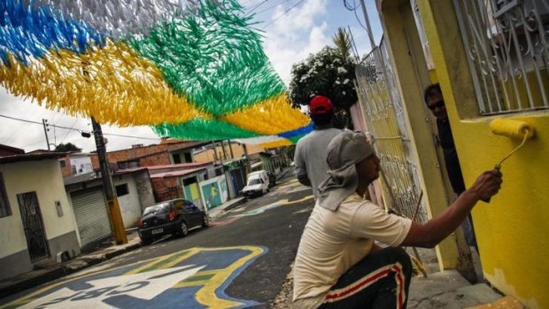 Neighbours in Manaus come together to decorate their houses ahead of the World Cup.