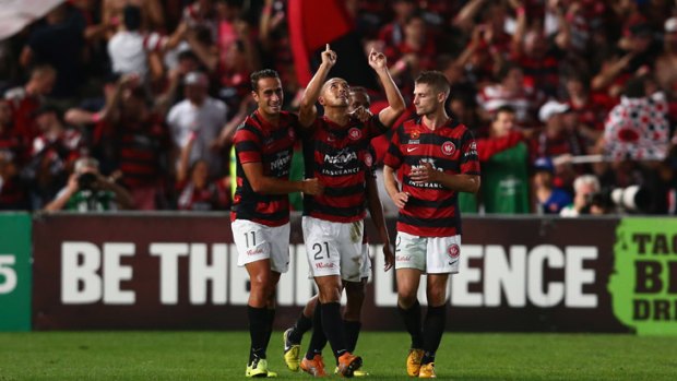 Shinji Ono (centre) is congratulated after scoring the decisive second goal for Wanderers.