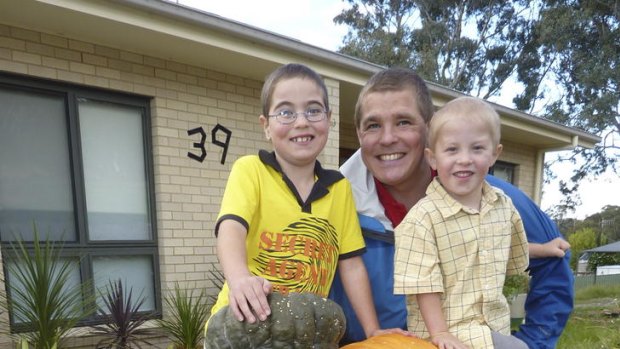 Elijah, 7, and Micah, 4, with their dad Jonathan Taylor and the pride of the their pumpkin patch.