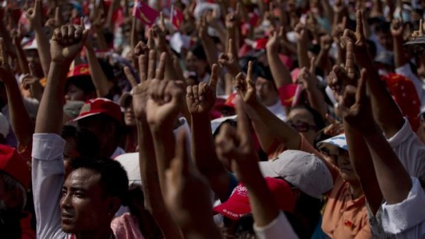 Voting for change: Supporters of Myanmar's opposition National League for Democracy  in a show of hands to amend the constitution at a rally on Saturday.