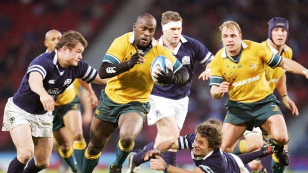 Former Wallaby Wendell Sailor powers through the Scottish backline in 2004.